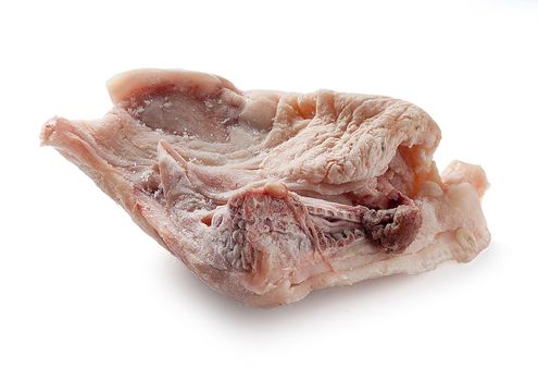 Frozen piece of chicken meat on the white background