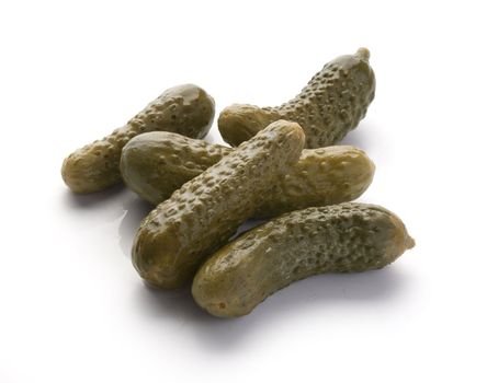 Some small marinated cucumbers in the white background