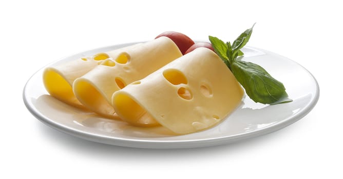 Rolled pieces of cheese with tomato and basil on the plate