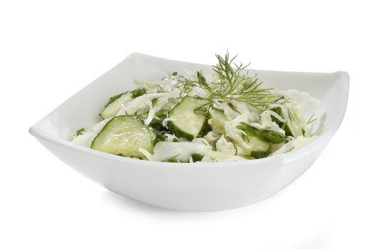 Salad with cabbage and cucumber in the white bowl