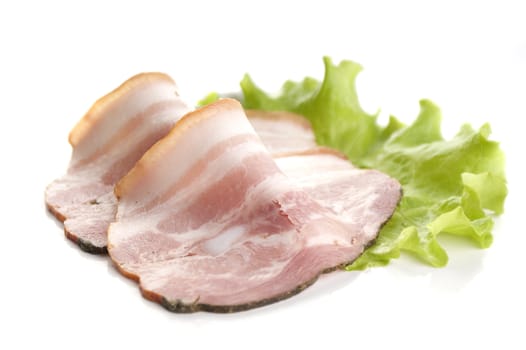 Two pieces of bacon on the fresh lettuce