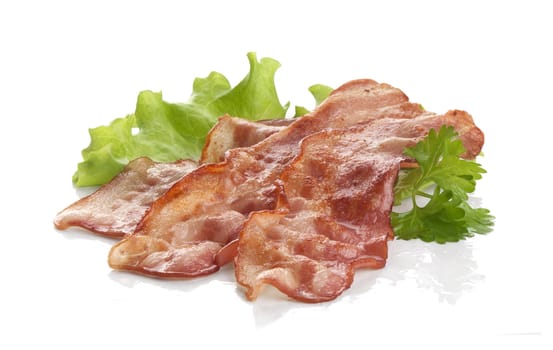 Three pieces of fried bacon with parsley and lettuce on the white
