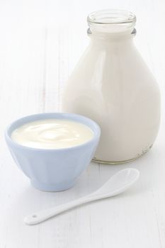 Delicious, nutritious and fresh plain yogurt and milk bottle.