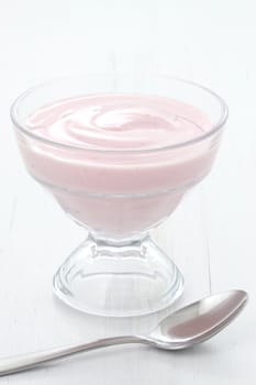 Fresh, healthy and delicious creamy, strawberry yogurt in vintage French cup, the perfect snack or dessert.