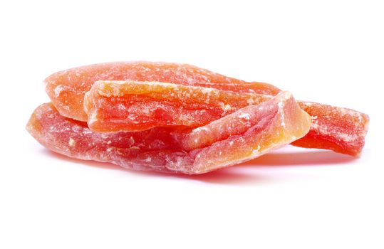orange dried papaya slices over white background