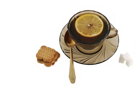Tea. A cup with tea, cookies, sugar, a lemon.