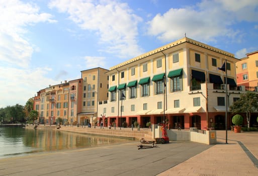 A hotel with a lake and blue sky.