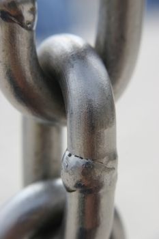 A macro photo of a link of a chain.