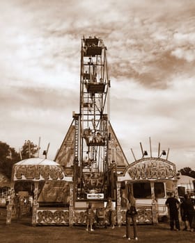 A ferris wheel in a fair ground.