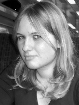 Victoria posing on a train in black and white.