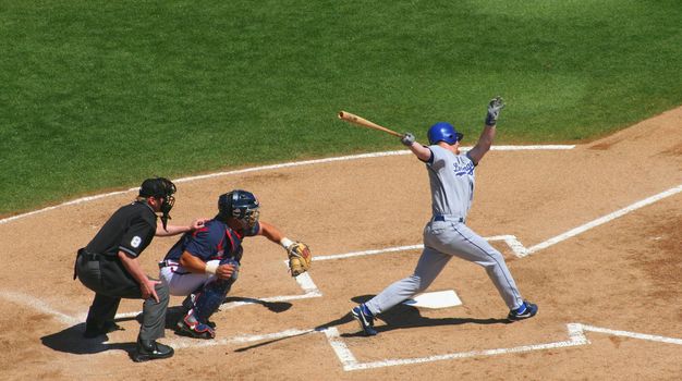 Playing baseball, batter, catcher and umpire