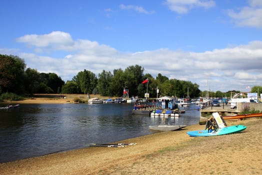 Christchurch river at a regatta with boats and sand.