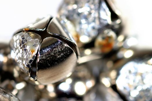 Silver shiny bells close up on white background