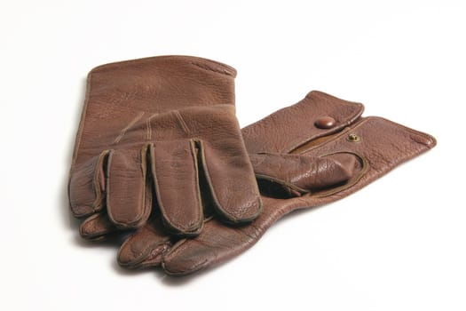 a pair of old brown leather gloves isolated on white background