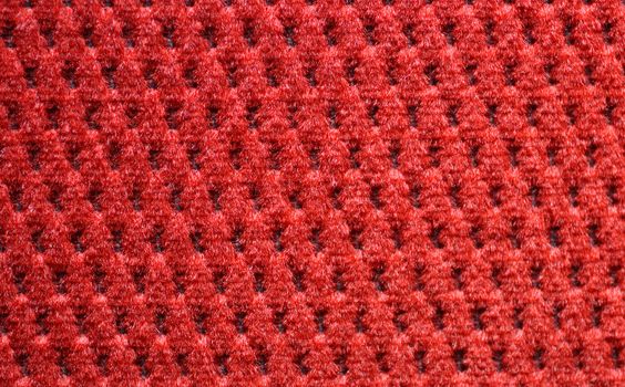 red upholster material of armchair close-up