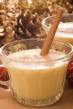 Festive eggnog served with a cinnamon stick.