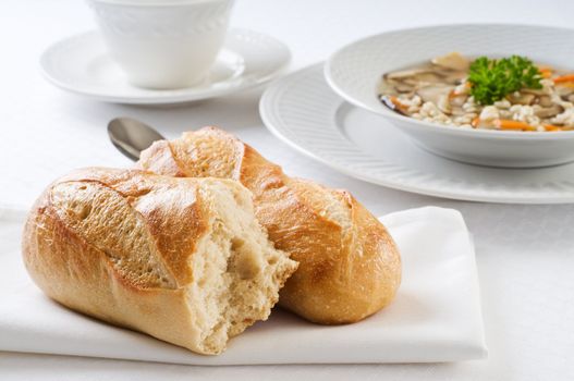 Fresh baked french baguette accompanying hot soup.