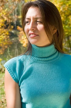 Autumn. The beautiful young woman against yellow leaves