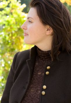 The beautiful young woman. Profile against autumn.