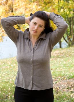 Autumn. Beautiful young woman against autumn park.