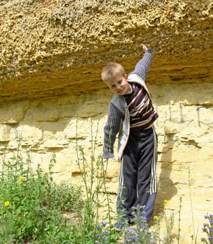 The smiling little boy against yellow rock
