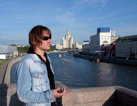 The young man against the river in Moscow.