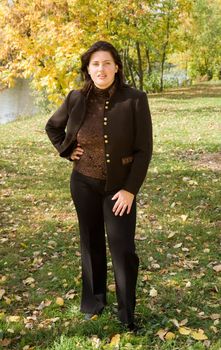 Autumn. Beautiful young woman against autumn park.
