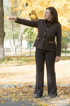 Autumn. Beautiful young woman against autumn park.