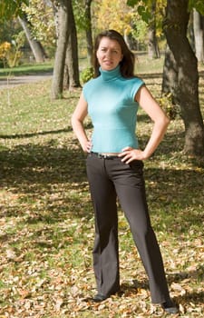Autumn. Beautiful young woman against autumn park.