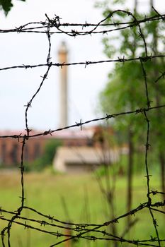 factory behind barbed wire