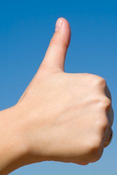 Thumbs up on a blue sky background