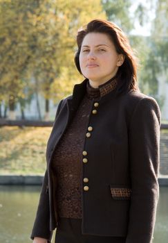 The beautiful young woman against the river