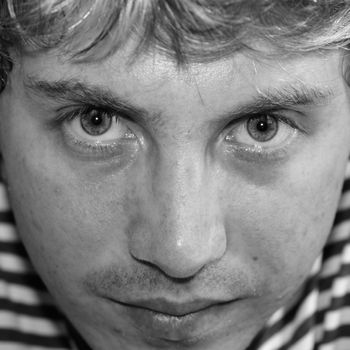 Sad young man close up. Black � and - white portrait.