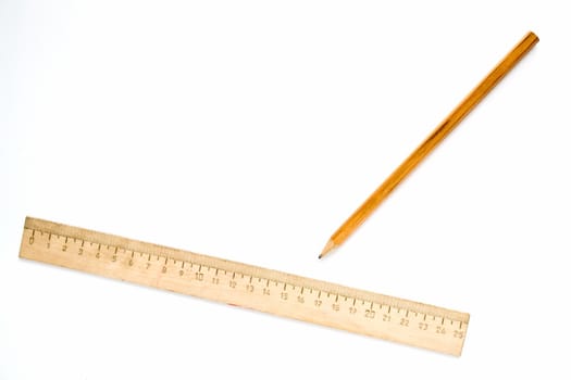 Wooden ruler and pencil on a white background