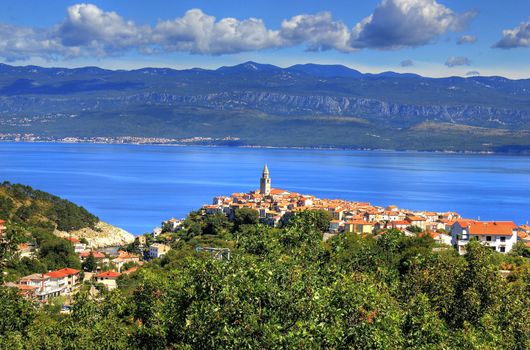 Mediterranean town of Vrbnik, Island of Krk, Croatia - town in northern Adriatic sea located on the high rock, known by the quality wine - vrbnicka zlahtina. Velebit mountain in the back.