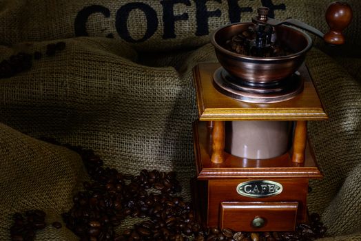 Coffee Mill with beans and burlap. still life