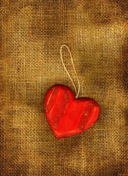 Red heart on a sackcloth in grunge.