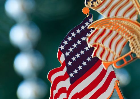 Christmas tree decorated with silver and white ribbons and US flag ornaments in family home