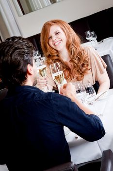 happy smiling couple in restaurant celebrate toast champagne dinner