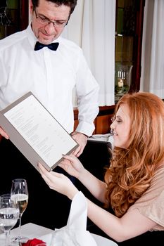 man and woman in restaurant waiter bring card and order food