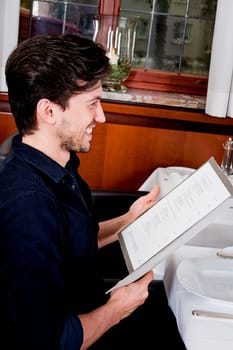 man and woman in restaurant waiter bring card and order food