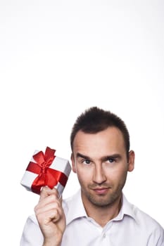 young handsome man holding a gift, over white background