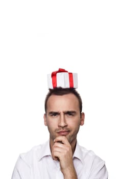 young handsome man with a gift on his head, over white background