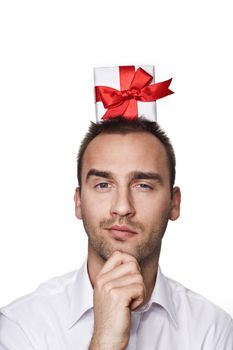 young handsome man with a gift on his head, over white background