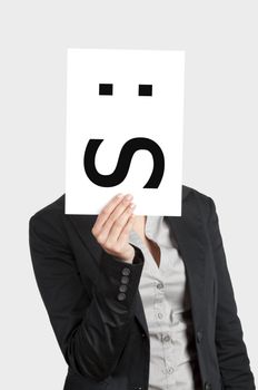 Woman showing a blank paper with a confused emoticon in front of her face