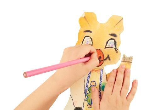 Children's hands paint crayon a paper figure of  cartoon pig
