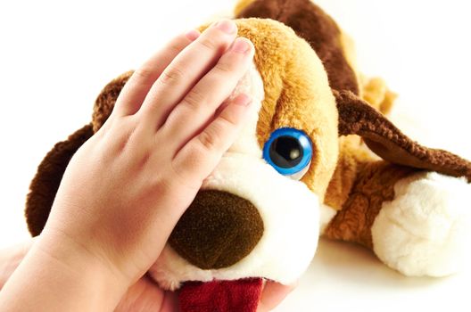 Child's hand with a toy on a white background