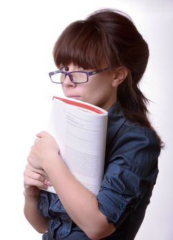 Portrait of young alluring brunette woman, holding book on white background