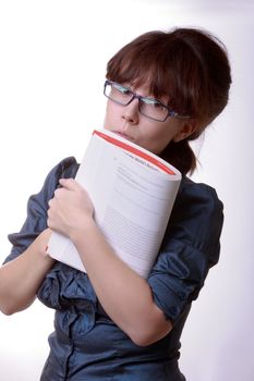 Portrait of young alluring brunette woman, holding book on white background