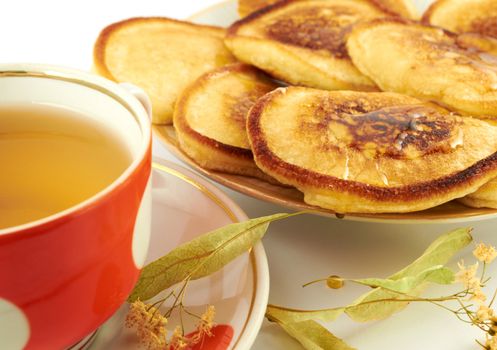 Pancakes  with honey and a cup of tea with linden 